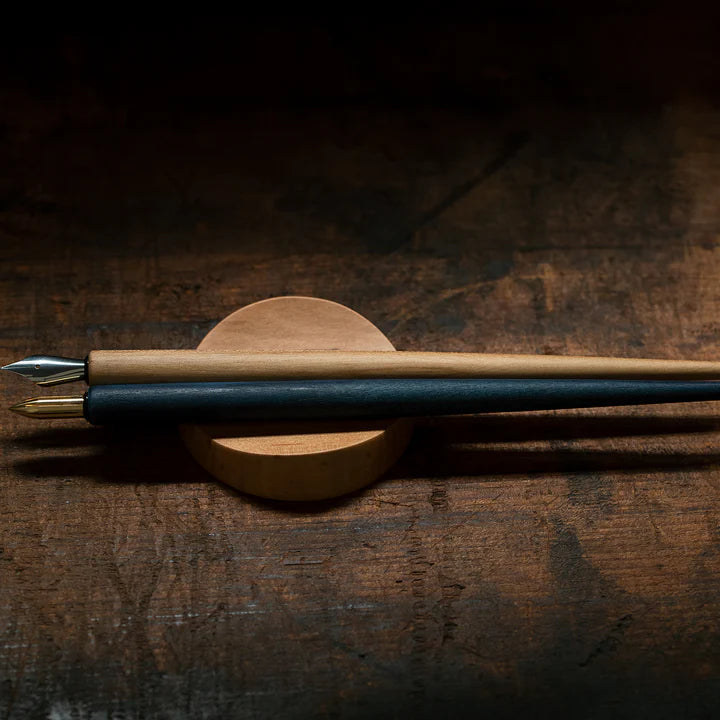 A pen rest that enhances the moments between writing. Designed to hold any pen without the need for precise placement, it blends effortlessly into your desk space with a subtle but assured presence. Enjoy the rich texture and wood grain of Japanese cherry.
Designed for stability to ensure your pens and surfaces are protected from accidental movement or damage. The pen rest comfortably holds two to three slender pens.
Use and Care:
To prevent distortion and discolouration, avoid soaking in water, sudden t