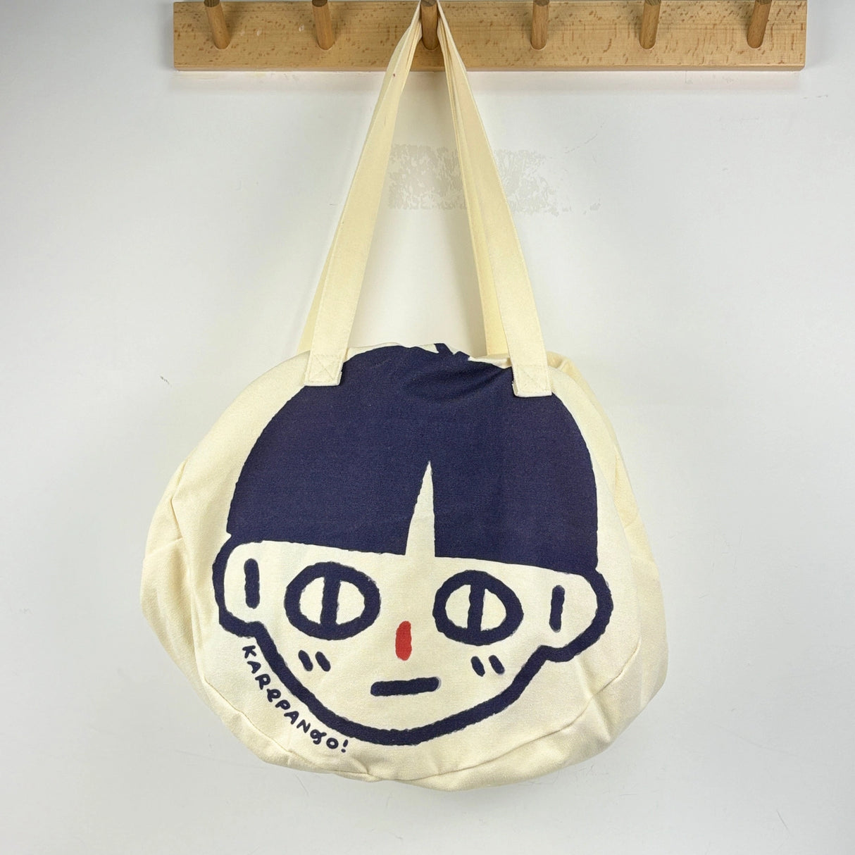 Karepango Haya: Large Zipper Tote Bag
Our signature tote bag with a signature face. Stand out with true character. Zipper closure on top.