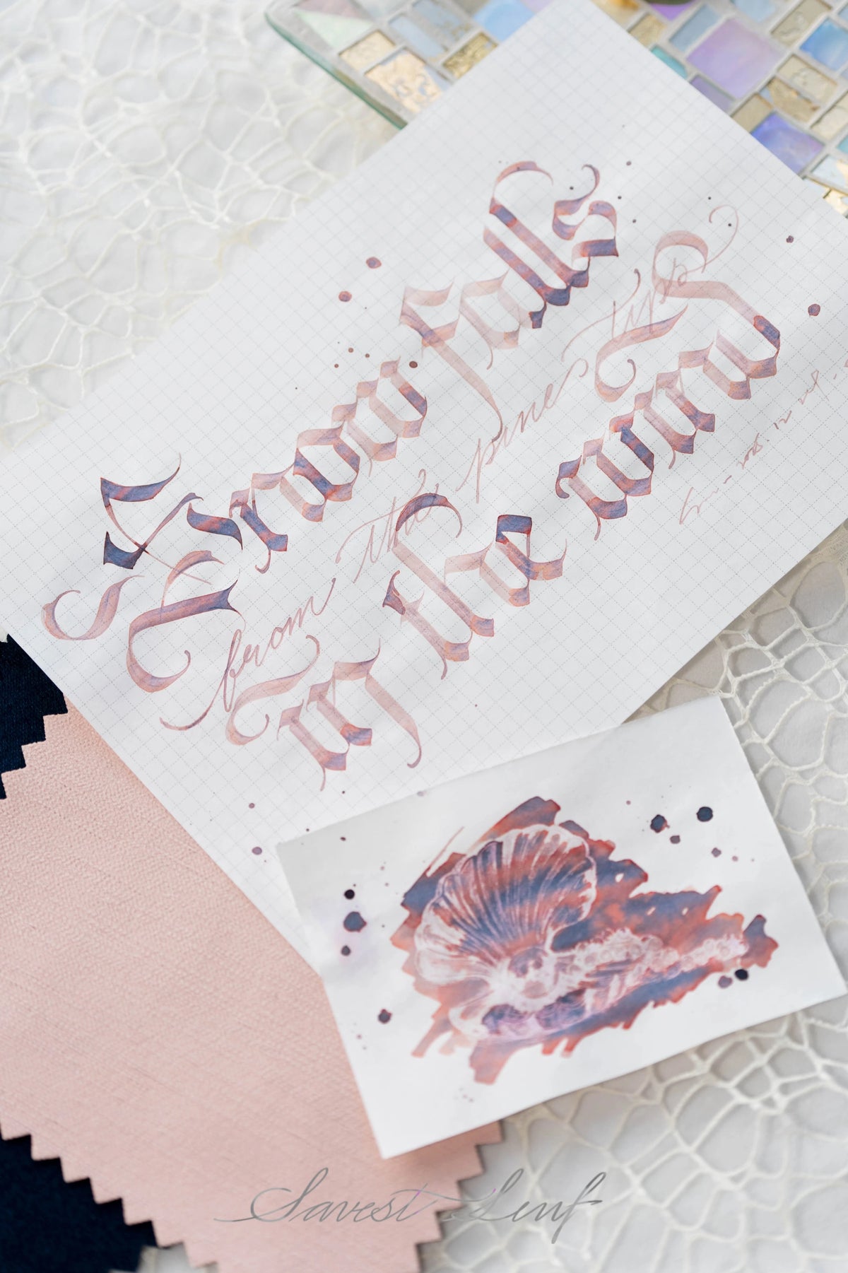 Snow Falls From the Pine Tips in the Wind is a serene winter ink that captures the quiet beauty of snowfall drifting through a forest at dawn. This multi‑shading fountain pen ink blends a soft rose‑mauve base with cool lavender and deep indigo shadows, creating a gentle, atmospheric palette that shifts with nib pressure and paper texture.