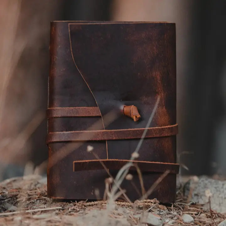 Kodiak Leather Traveler's Journal - Large
The Kodiak Traveler Journal is the perfect travel companion. Made with durable top grain leather, a leather wrap closure and handmade artisan paper this journal is the ultimate gift item for the world traveler or home-body.
• 110 blank pages
• Made with handmade artisan paper
• Top Grain Leather
• Dimensions: 8" x 6" x 1.75"