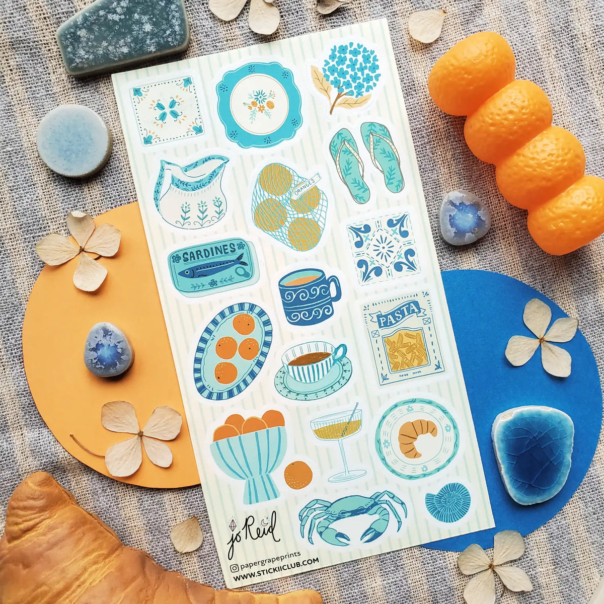 🩴🍊 @papergrapeprints is serving up a sun-soaked spread of seaside favorites, and we’ll take one of everything! Bright oranges, sardines, pasta, pretty ceramics, hydrangeas, and that perfect blue crab come together in a dreamy mix of coastal color and vacation-day charm. Add flip-flops, something cold to sip, and absolutely zero plans. Art by: @papergrapeprints
Top Coating: None
Adhesive Layer: Paper
Backing Layer: Clear PET
6.69" x 3.54".
Weight - 0.03lbs
1 sheet included