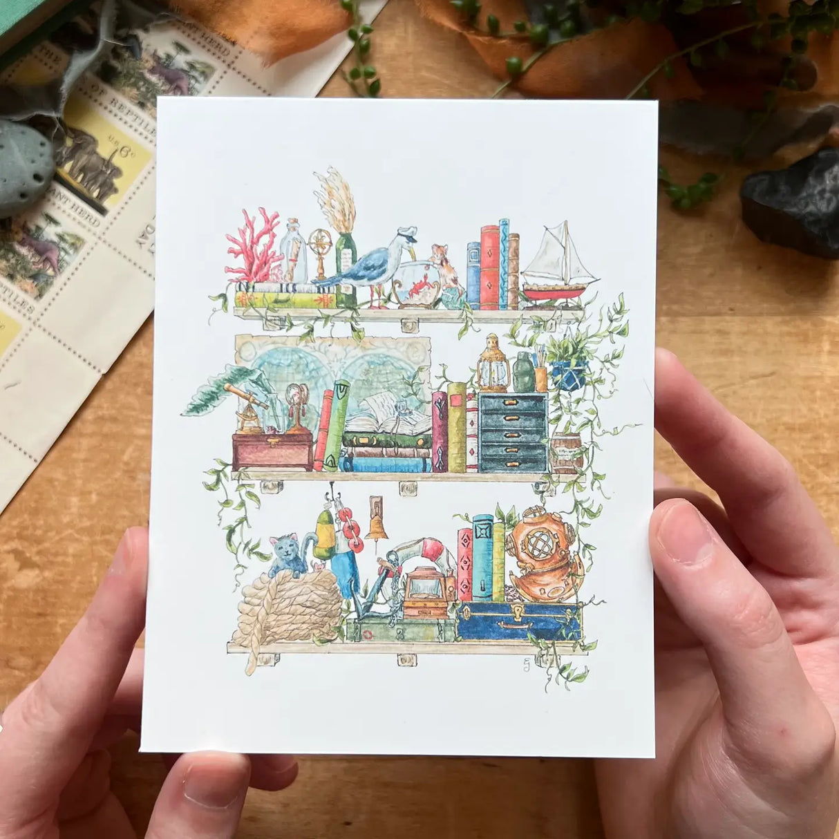 Postcard featuring my original watercolor and ink illustration of the oddities, books, and tools tucked away in the shelves of a vintage sailor, including an inquisitive seagull in a captain’s hat, a diving helmet, and a message in a bottle.
• Printed on high quality card stock
• Each postcard measures 4.25 x 5.5" (A2)