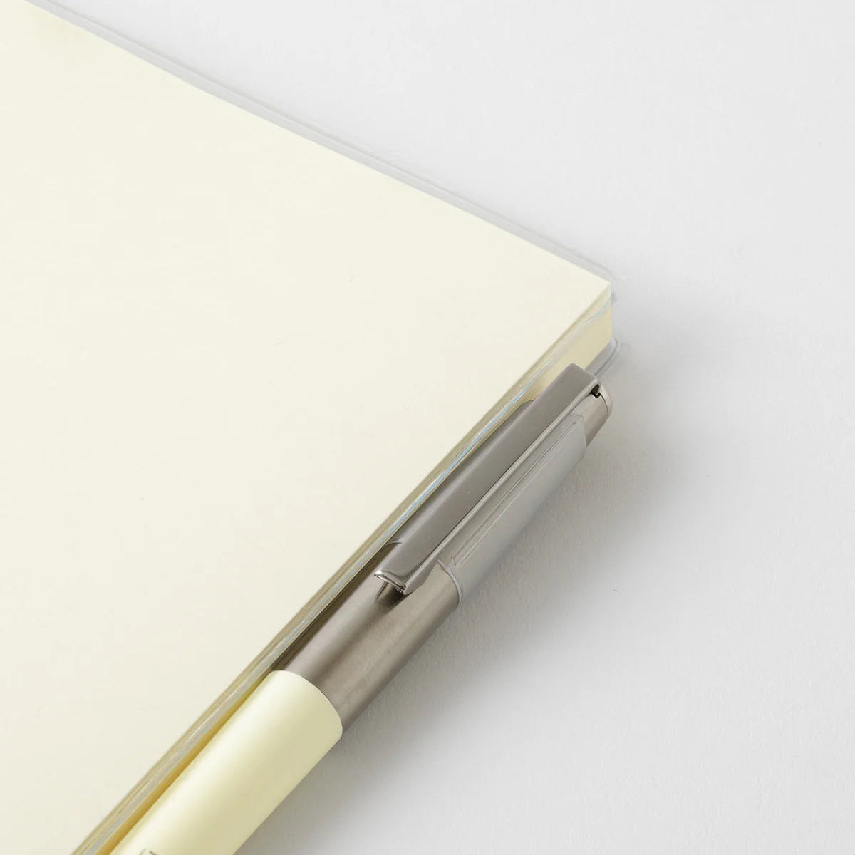 A transparent cover that fits snugly around your MD Notebook
This is a special cover that gently wraps your MD Notebook. The transparent cover protects the notebook from dirt without ruining its appearance.
It subtly protects your notebook from water and dirt without interfering with its characteristics. If you put the cover on with the glassine paper still wrapped around it, the inorganic feel of the vinyl will be softened.
Because it is transparent, you can enjoy the cover design, illustrations, and writ