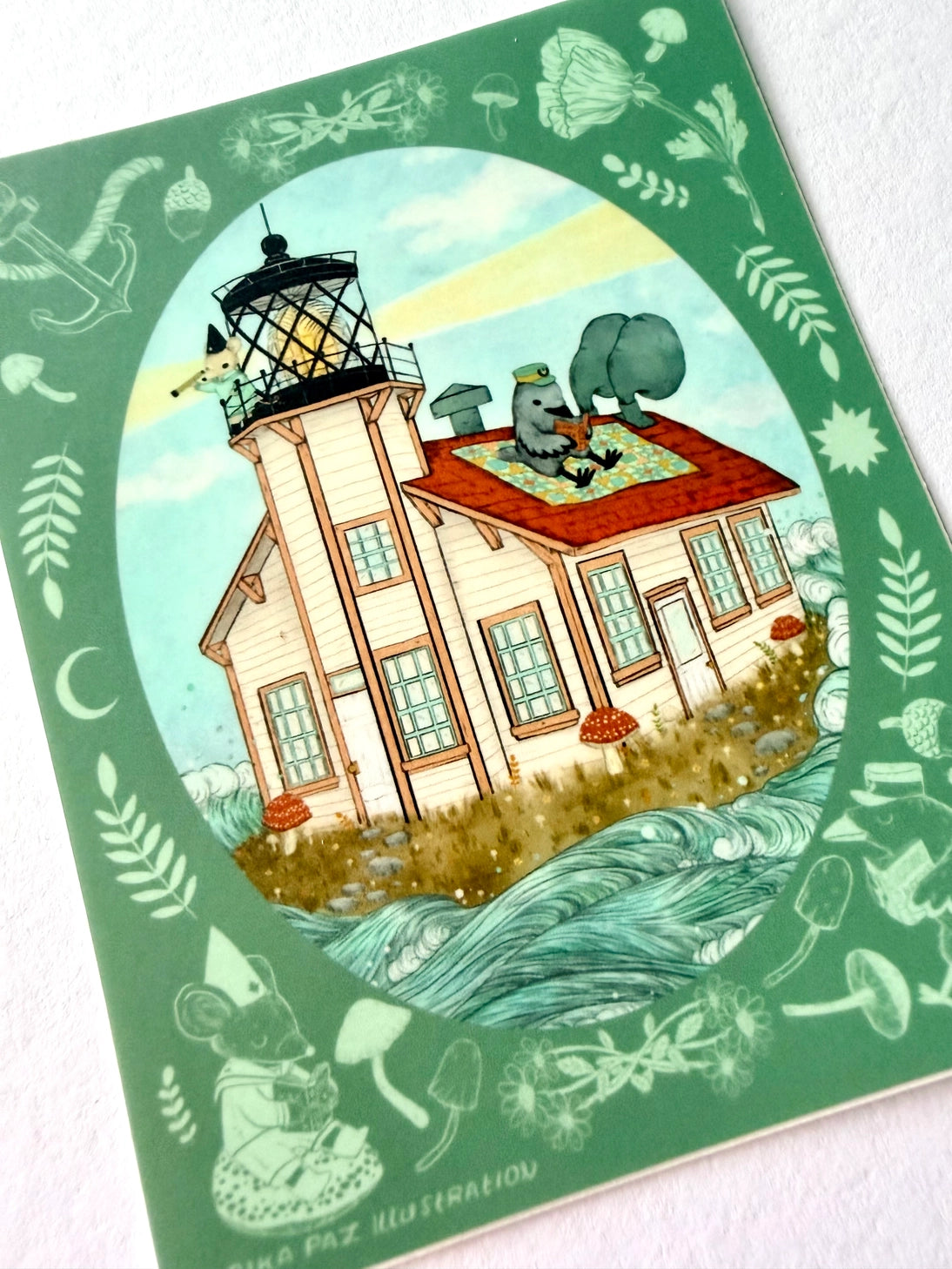 A raven and mouse attend to their lighthouse amongst the waves.
This vinyl matte sticker is weather and waterproof-stick it on a notebook, bike, or car- it's going to stick around! Heck, throw it on a water bottle and through the dishwasher. This sticker can go anywhere. Sticker measures 4.5" x 4.5" Printed in USA.