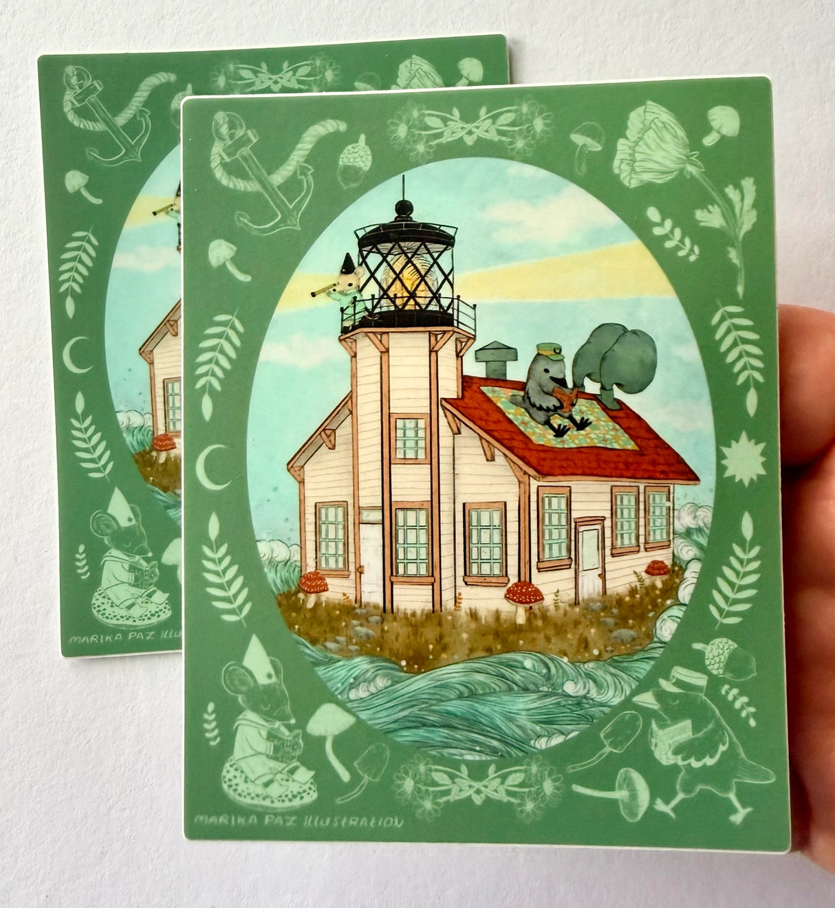 A raven and mouse attend to their lighthouse amongst the waves.
This vinyl matte sticker is weather and waterproof-stick it on a notebook, bike, or car- it's going to stick around! Heck, throw it on a water bottle and through the dishwasher. This sticker can go anywhere. Sticker measures 4.5" x 4.5" Printed in USA.
