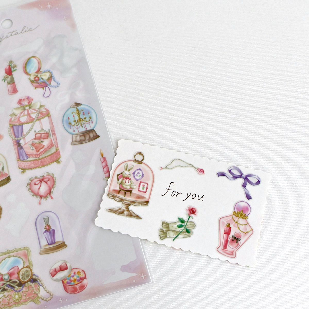 This is an illustration sticker that traps a fantasy world view and motif in a glass container like a snow globe or terrarium. It is a sparkling hologram specification.
• This package includes 1 sheet of sticker
• Material: Transparent PET Hologram Lamination
• Package measures approx. H202 x W93 x D1mm
• Made in Japan