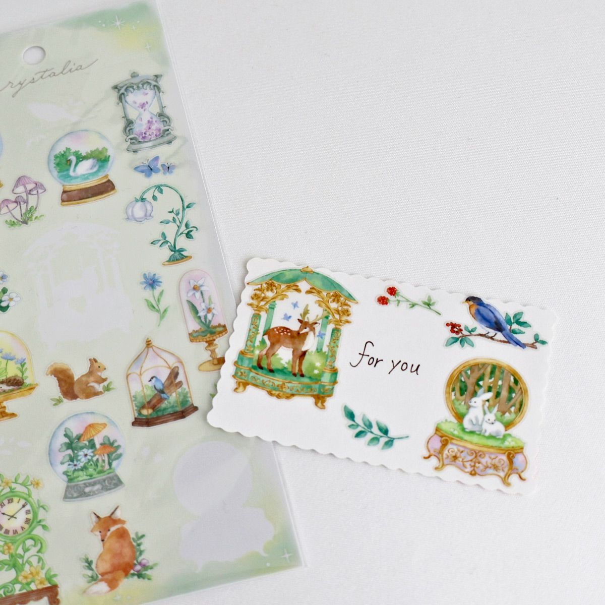 This is an illustration sticker that traps a fantasy world view and motif in a glass container like a snow globe or terrarium. It is a sparkling hologram specification.
• This package includes 1 sheet of sticker
• Material: Transparent PET Hologram Lamination
• Package measures approx. H202 x W93 x D1mm
• Made in Japan