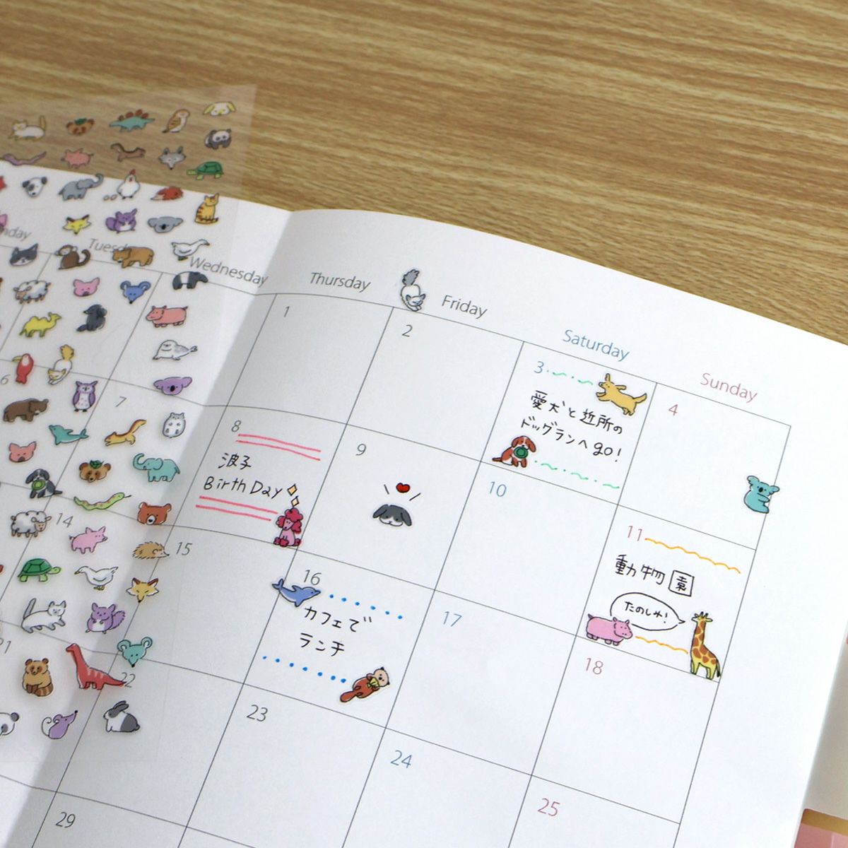 Calendar with animal stickers on a wooden surface