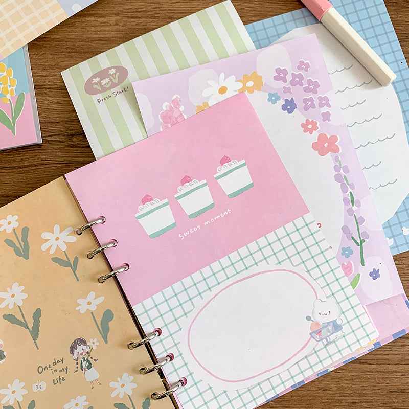 Molinta - Gentle Dreams A5 Colored Notepad
Enjoy 5 sets of 12 different designs that total to 60 sheets that can be used for various purposes such as gift wrapping or making cute collages in your journal!
Specifications: 148mmx210mm
Material: 100g white kraft paper
Full color pages inside
Number of pages: 60