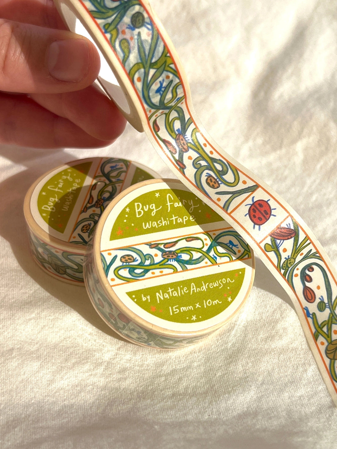 This washi tape features little bugs hidden in vines! Taken from the borders of my Bug Fairy print.
This roll is 15mm wide x 10m of paper tape. Washi tape is super durable and flexible. It tears easily and can be safely applied to a variety of surfaces; it doesn’t leave a sticky residue behind, making it especially ideal for stationery and hanging prints temporarily.