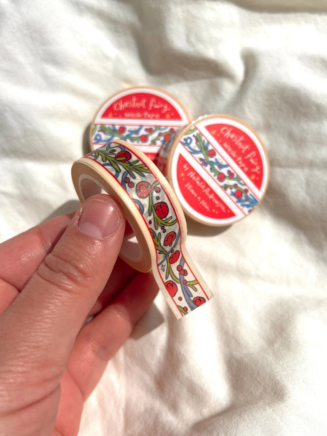 This washi tape was designed from my Chestnut Fairy Riso print! Looks like classic book art decorations with a vibrant red block separating each section.
This roll is 15mm wide x 10m of paper tape. Washi tape is super durable and flexible. It tears easily and can be safely applied to a variety of surfaces; it doesn’t leave a sticky residue behind, making it especially ideal for stationery and hanging prints temporarily.