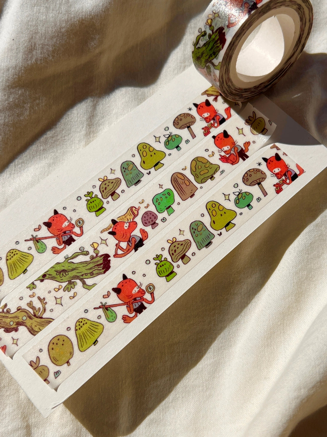 This washi tape features a little fox on their adventures through the mushroomy forest!
This roll is 15mm wide x 10m of paper tape. Washi tape is super durable and flexible. It tears easily and can be safely applied to a variety of surfaces; it doesn’t leave a sticky residue behind, making it especially ideal for stationery and hanging prints temporarily.