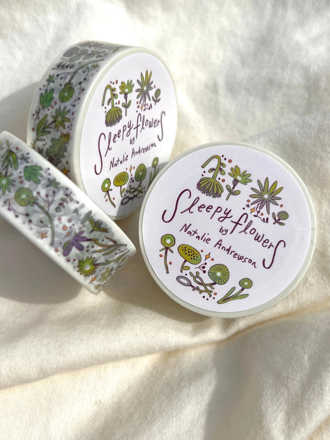This washi tape features fluid green and purple flowers dancing loosely around to create an energetic, yet soft tape.
This roll is 15mm wide x 10m of paper tape. Washi tape is super durable and flexible. It tears easily and can be safely applied to a variety of surfaces; it doesn’t leave a sticky residue behind, making it especially ideal for stationery and hanging prints temporarily.