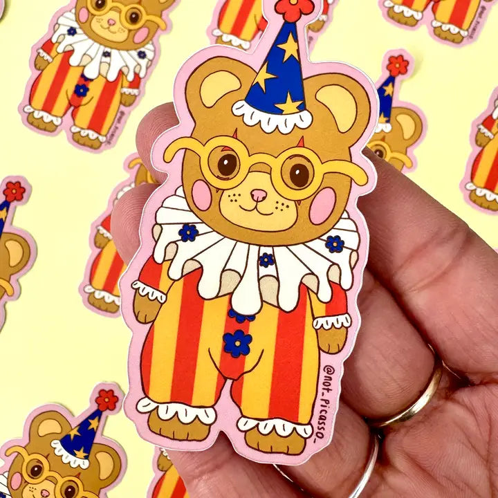 These adorable stickers feature a cute little bear in a clown suit.
These matte vinyl stickers feature an original design and are water, weather, and scratch proof. Perfect for putting on water bottles, computers or just about anywhere else.