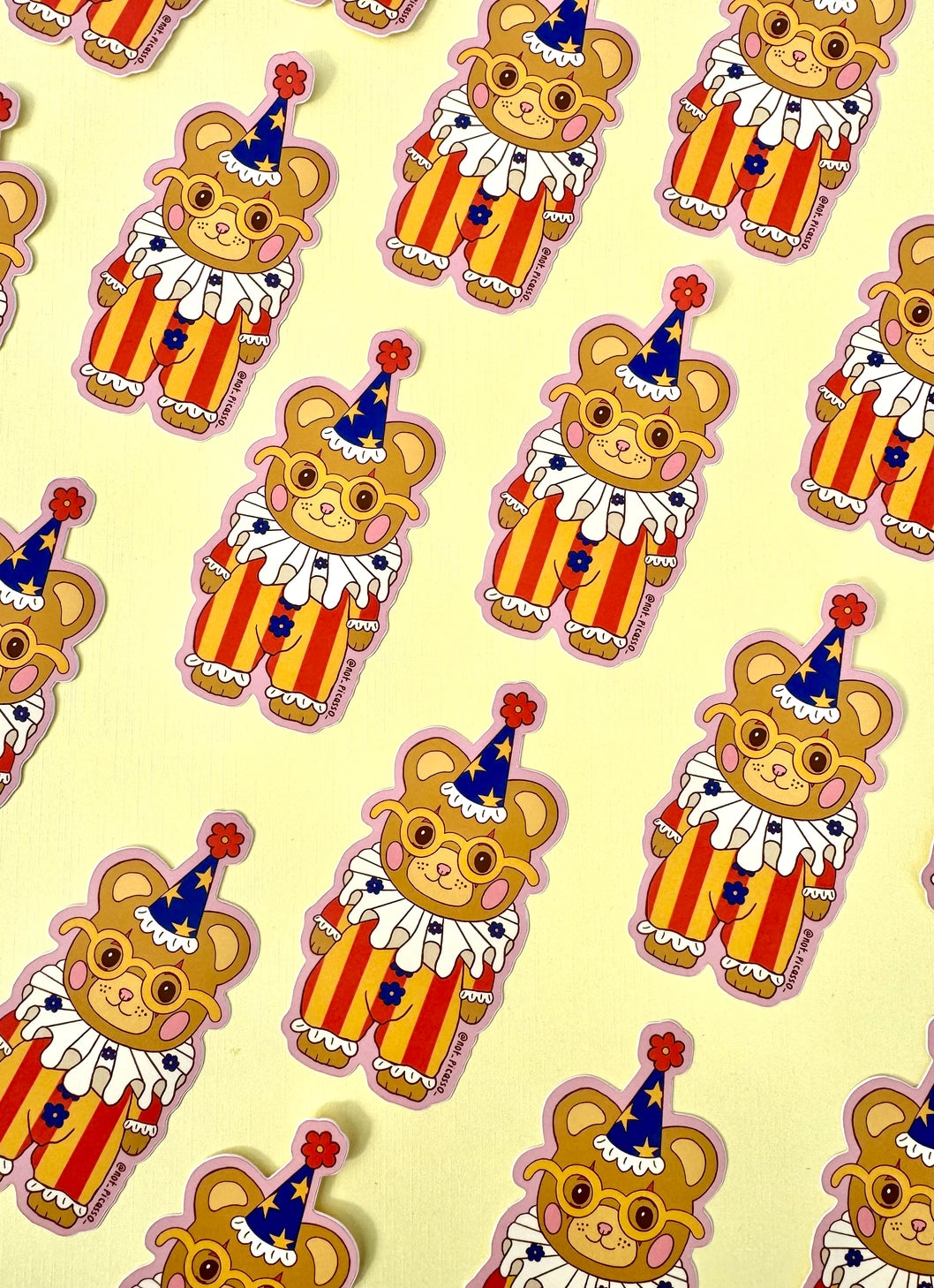 These adorable stickers feature a cute little bear in a clown suit.
These matte vinyl stickers feature an original design and are water, weather, and scratch proof. Perfect for putting on water bottles, computers or just about anywhere else.