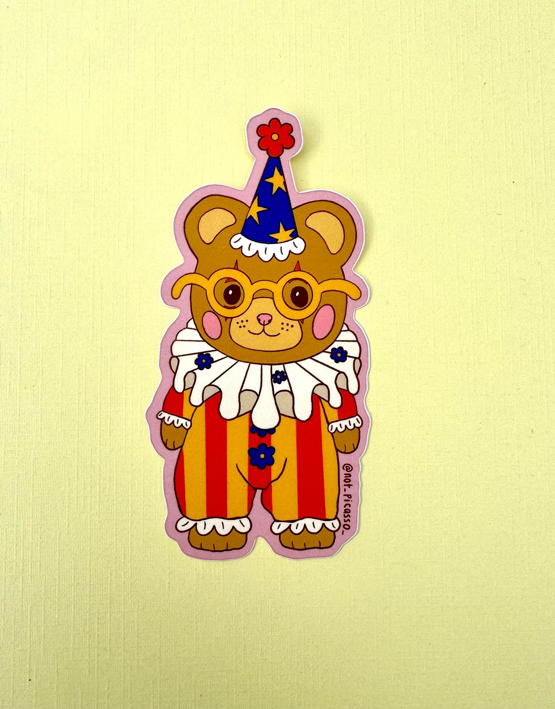 These adorable stickers feature a cute little bear in a clown suit.
These matte vinyl stickers feature an original design and are water, weather, and scratch proof. Perfect for putting on water bottles, computers or just about anywhere else.