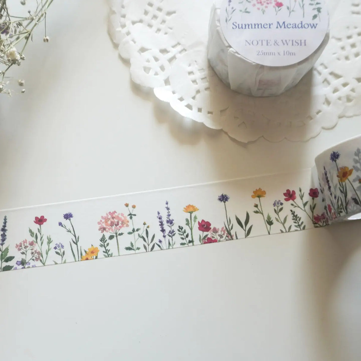 This wildflower washi tape is inspired by long summer walks through British meadows in full bloom. Featuring hand-drawn cornflowers, lavender and red flax, it captures that warm feeling of a summer afternoon surrounded by wildflowers. Designed and hand drawn in the UK by Rebecca.
Length: 10m
Width: 25mm