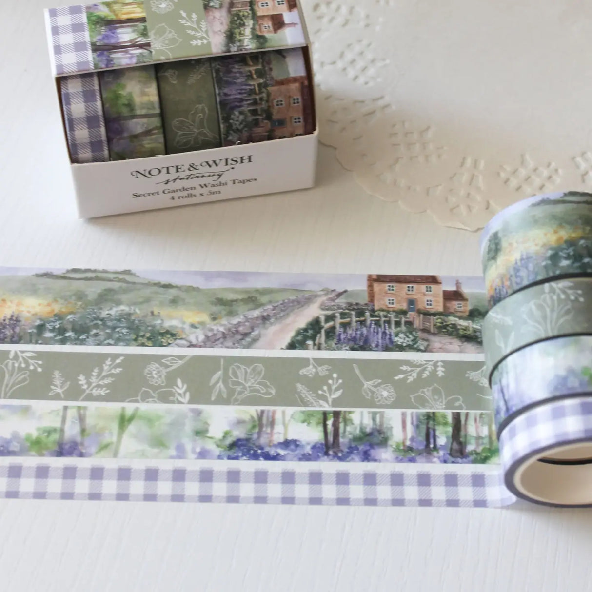 This beautiful washi tape gift set is designed for journalers, nature lovers and stationery lovers who find beauty in the quiet corners of the British countryside. Featuring original watercolour paintings by Rebecca, this set is inspired by walks through a bluebell wood and a secret garden in full bloom.
The two designs included:
Bluebell Woods — a hand-painted watercolour scene of a bluebell wood - 15mm x 5m
Secret Garden — a beautiful cottage and garden scene, hand-painted in soft watercolours - 2