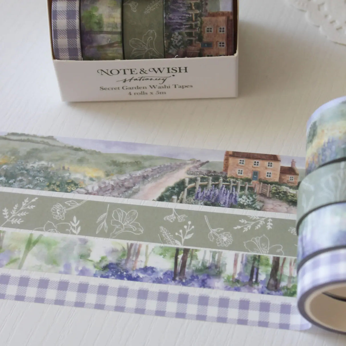 This beautiful washi tape gift set is designed for journalers, nature lovers and stationery lovers who find beauty in the quiet corners of the British countryside. Featuring original watercolour paintings by Rebecca, this set is inspired by walks through a bluebell wood and a secret garden in full bloom.
The two designs included:
Bluebell Woods — a hand-painted watercolour scene of a bluebell wood - 15mm x 5m
Secret Garden — a beautiful cottage and garden scene, hand-painted in soft watercolours - 2