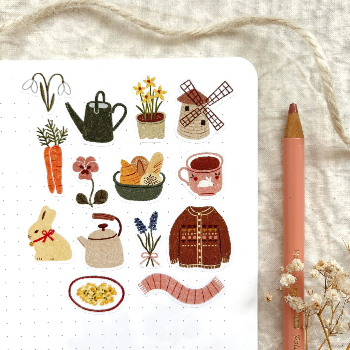 A matte paper sticker sheet filled with cozy, hand-drawn illustrations, perfect for planners, journals, or scrapbooking. It features a cozy spring and hygge season theme, making it a perfect fit for mindful living enthusiasts. All designs are lovingly created by Monika Szczerbińska.