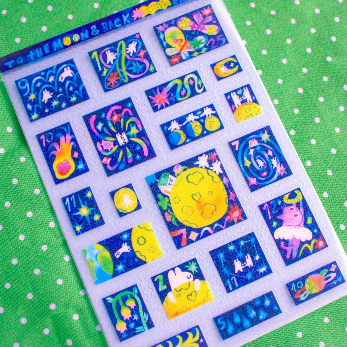 'To the Moon & Back' Frosted Glitter Transparent A6 Sticker Sheet. Stickers are stamp shaped and have a clear blue background.
Not waterproof.
Do not place in areas of high wear (laptops, phone cases, water bottles, etc).
Sticker sheets come packaged in a plastic sleeve.