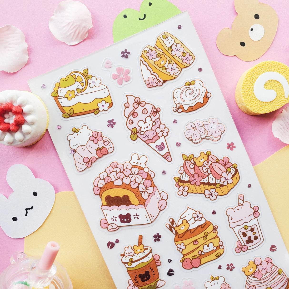 🌸🍰 Welcome springtime sweetness! This adorable sheet by @littlehecki is bursting with sakura magic and yummy café treats. From fluffy shortcakes and swirly cream rolls to dreamy parfaits, sakura cupcakes, and pastel milk teas, every dessert feels kissed by cherry blossoms. It’s like a cherry blossom picnic in sticker form — petals drifting through the air, sunshine on your cheeks, and sweet seasonal treats all around.
Art by: @littlehecki
Top Coating: None
Adhesive Layer: PVC (plastic)
Backing Layer: Cl