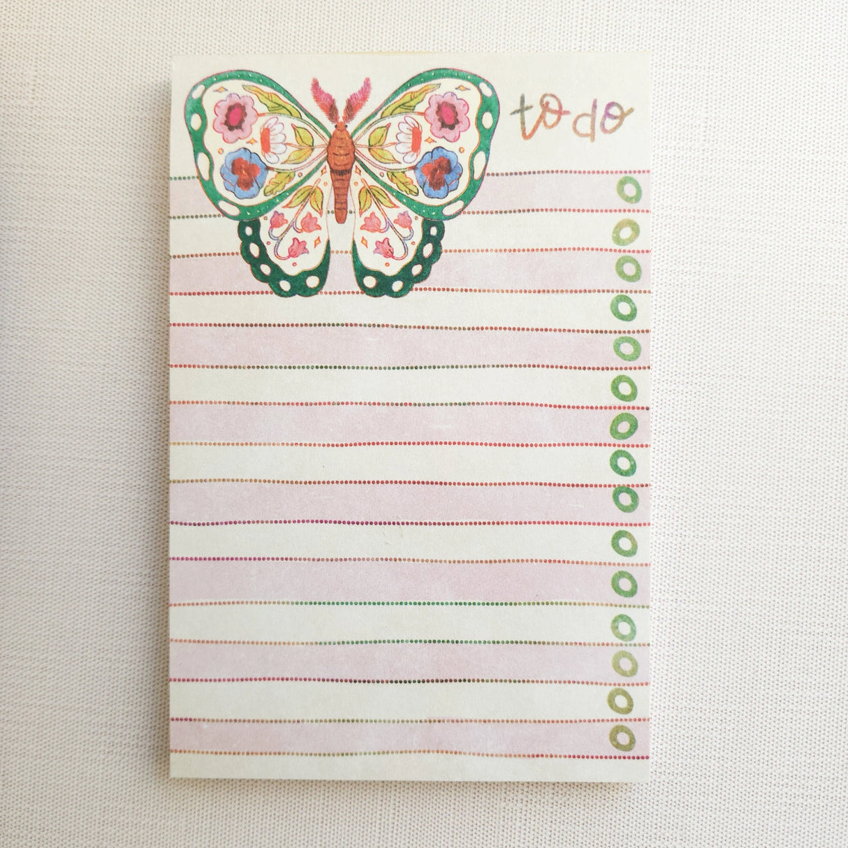 In the gardens of Wildflower Woods, a butterfly drifts from bloom to bloom, wings patterned with flowers gathered along the way. This notepad brings that light, floral moment to your desk, making everyday lists feel a little more inviting.
Designed to be practical without feeling busy, this notepad offers a simple, cheerful way to keep track of daily to-do lists and planning.