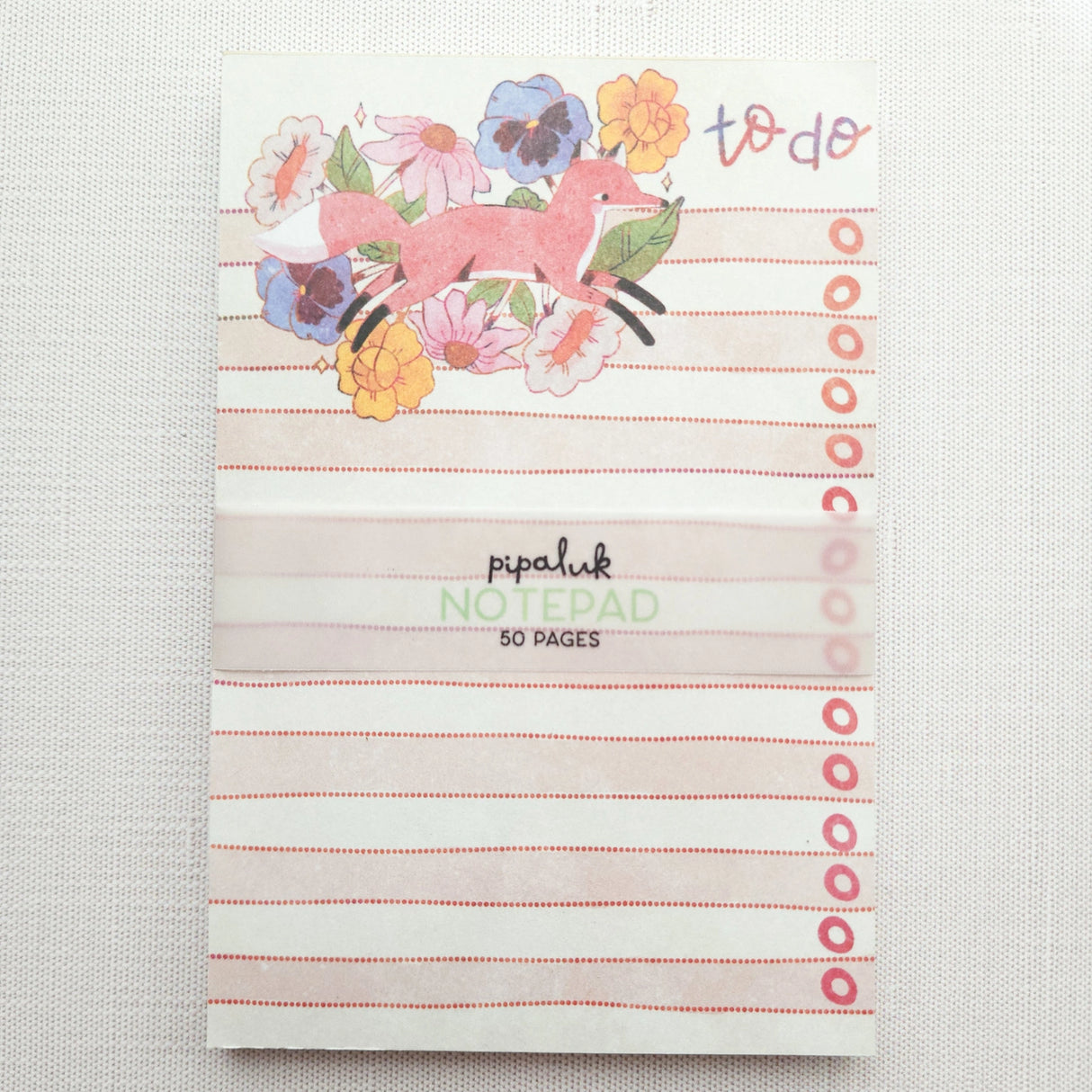 In a quiet clearing of Wildflower Woods, a fox moves through blooming flowers, petals lifting gently as he passes beneath open sky. This notepad brings that playful, woodland moment to your desk, making everyday lists feel a little more inviting.
Designed to be practical without feeling busy, this notepad offers a simple, cheerful way to keep track of daily to-do lists and planning.