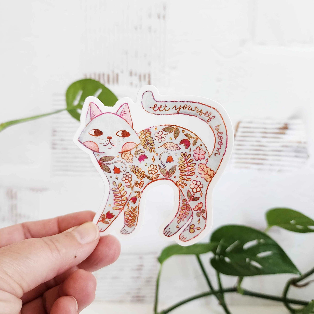 A calm cat returns from the blooming meadows of Wildflower Woods, patterned with flowers gathered along the way. This vinyl sticker captures that quiet, reflective moment, carrying a simple reminder to let yourself bloom.
Made from durable, waterproof vinyl, this sticker is designed to hold up wherever you place it—whether that’s a water bottle, laptop, or journal you reach for daily.