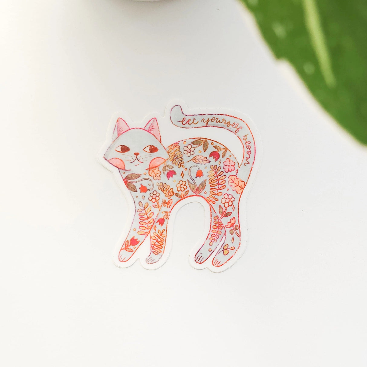 A calm cat returns from the blooming meadows of Wildflower Woods, patterned with flowers gathered along the way. This vinyl sticker captures that quiet, reflective moment, carrying a simple reminder to let yourself bloom.
Made from durable, waterproof vinyl, this sticker is designed to hold up wherever you place it—whether that’s a water bottle, laptop, or journal you reach for daily.