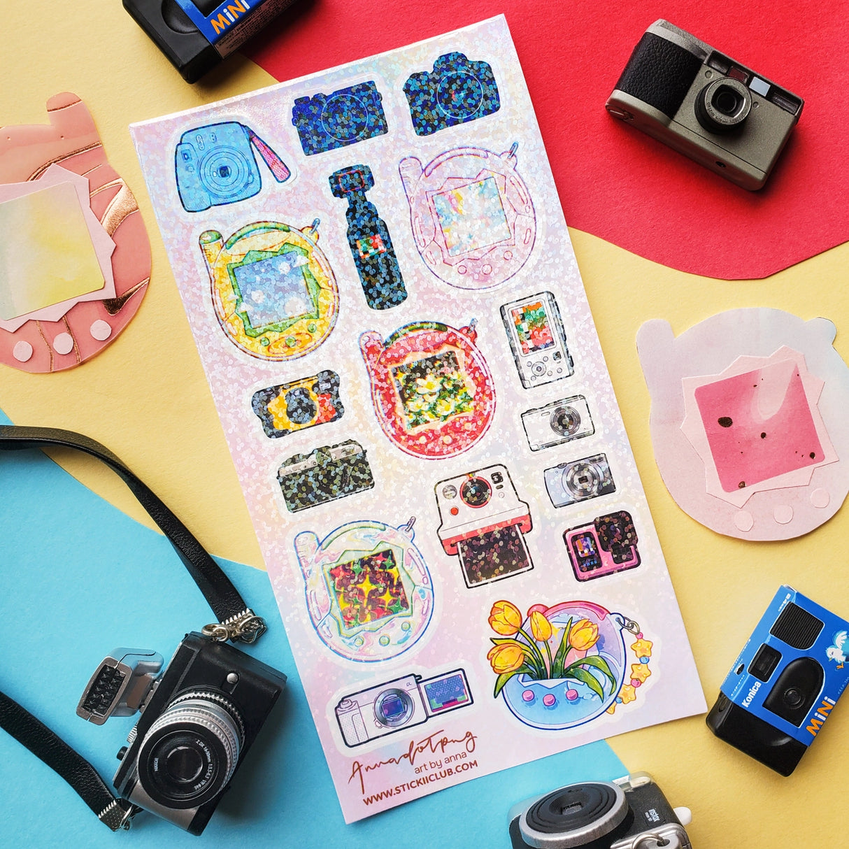 📸✨ Say cheese! From chunky digicams and instant printers to retro film cameras and pocket-sized pixel pets, this snap-happy sheet by @annadotpng is fully loaded with snapshot nostalgia. It’s a shutterbug’s dream, packed with dreamy screens and gadgets that totally flash back. Ready to capture some sticker magic? Point, shoot, print, repeat!
Art by: @annadotpng
Top Coating: Holo Glitter
Adhesive Layer: PVC (plastic)
Backing Layer: Clear PET
6.69" x 3.54".
Weight - 0.03lbs.
1 sheet included 