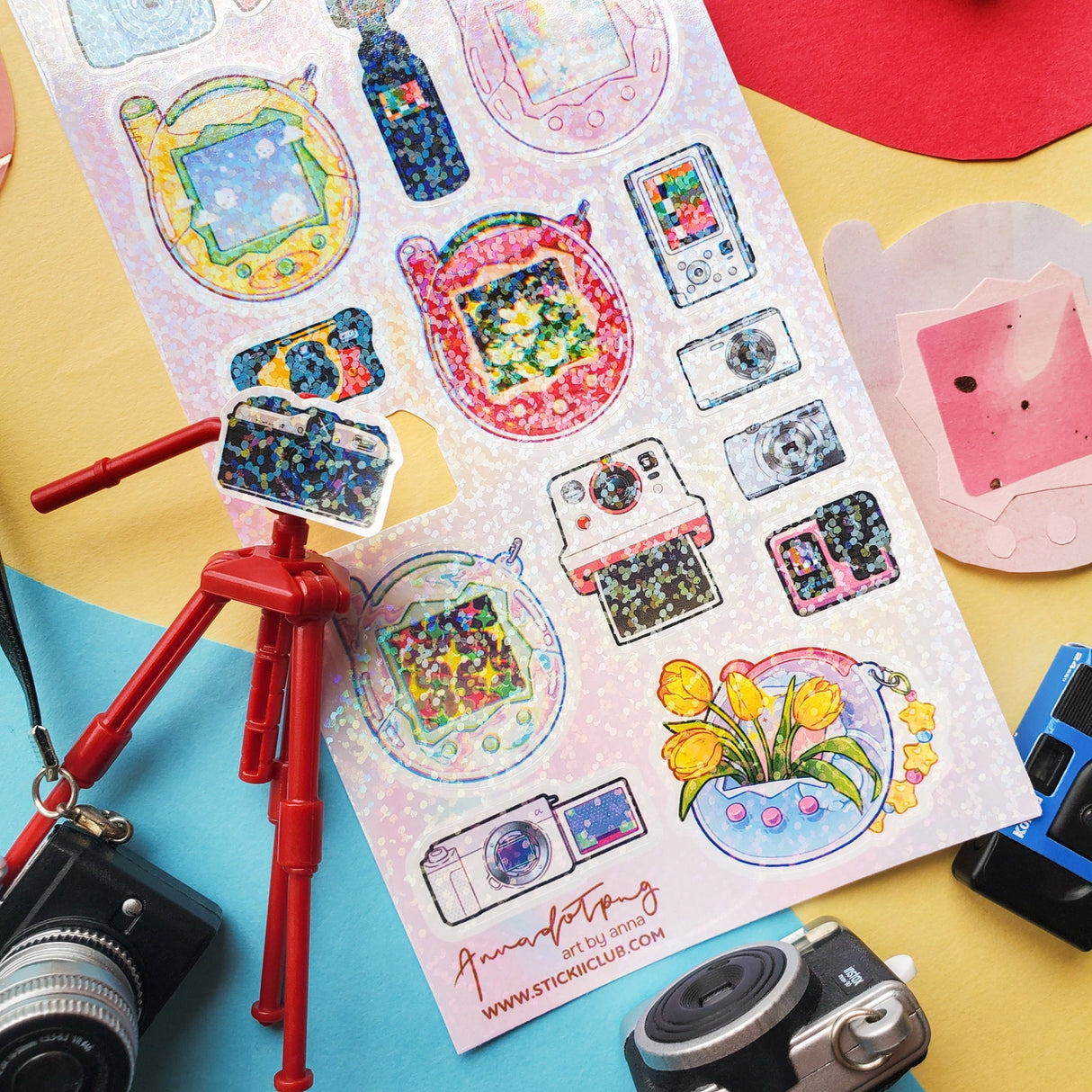 📸✨ Say cheese! From chunky digicams and instant printers to retro film cameras and pocket-sized pixel pets, this snap-happy sheet by @annadotpng is fully loaded with snapshot nostalgia. It’s a shutterbug’s dream, packed with dreamy screens and gadgets that totally flash back. Ready to capture some sticker magic? Point, shoot, print, repeat!
Art by: @annadotpng
Top Coating: Holo Glitter
Adhesive Layer: PVC (plastic)
Backing Layer: Clear PET
6.69" x 3.54".
Weight - 0.03lbs.
1 sheet included 