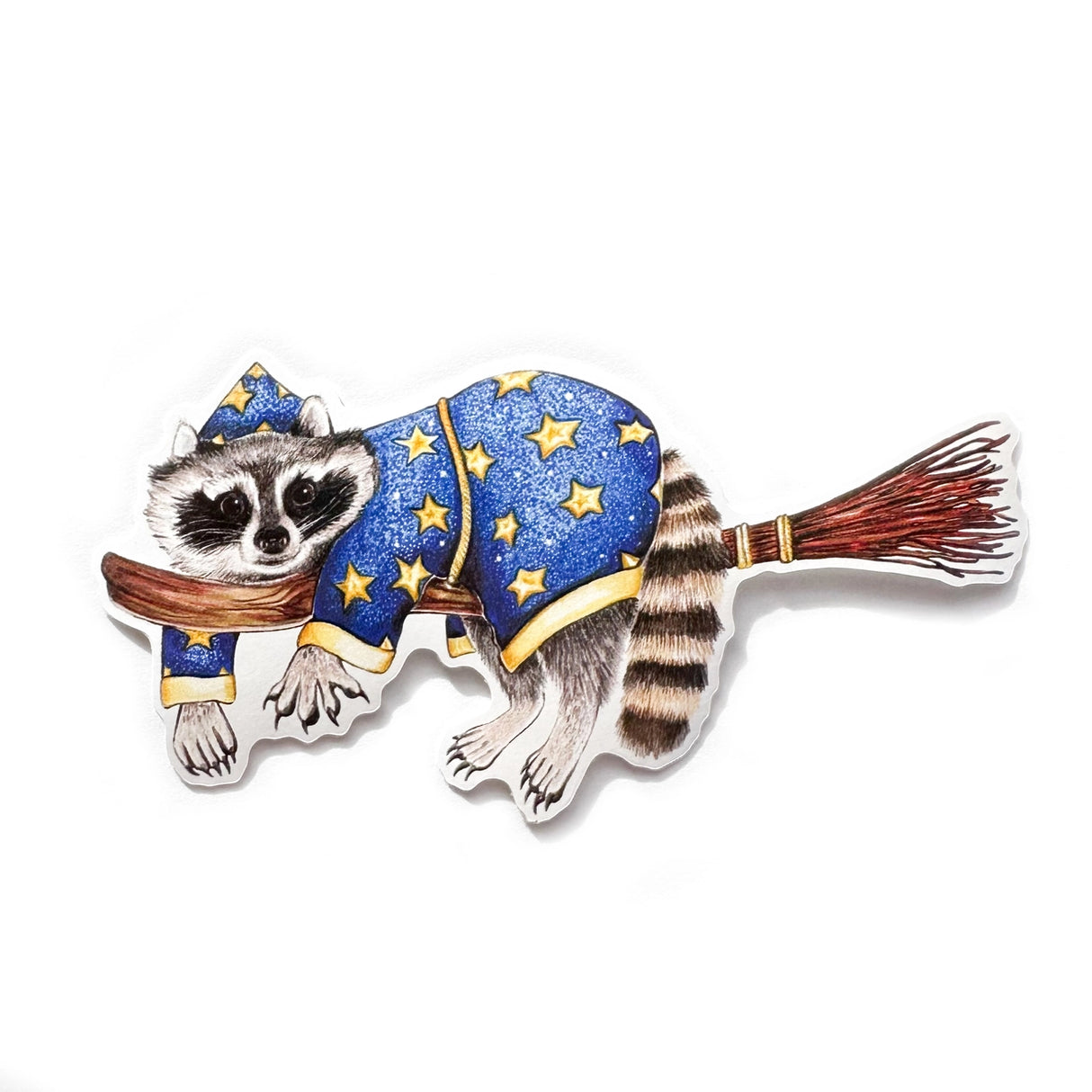 A sticker with my illustration of a wizard raccoon riding on a broom.
This die-cut vinyl sticker is durable and perfect for water bottles, notebooks, laptops, bikes, and all sorts of other surfaces! Make sure to clean and dry the surface thoroughly before applying.
