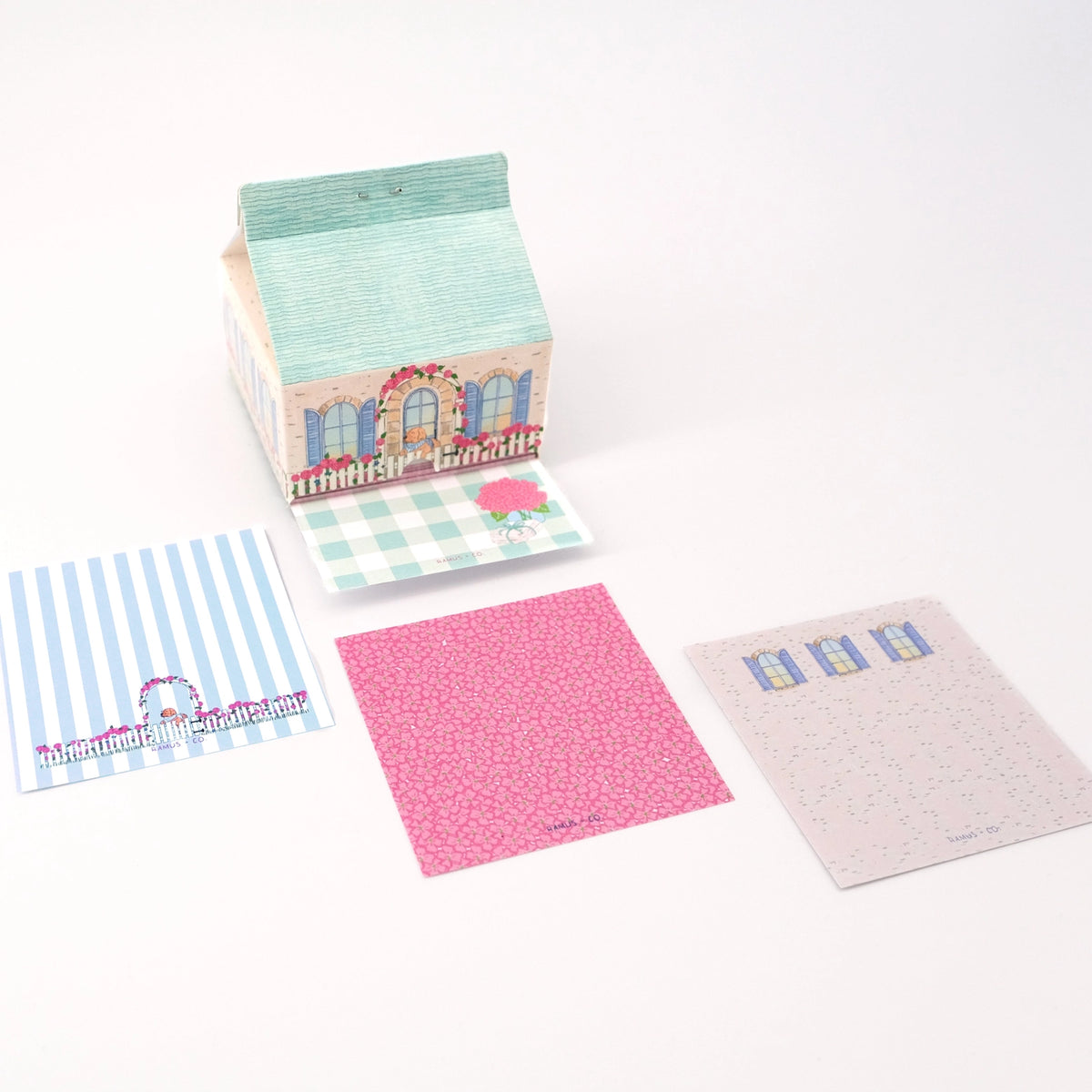 Ramus & Co. - Cottage Note Carton
Fresh notes, served daily! This Ramus & Co. mini carton comes filled with 200 handy 3×3 inch paper notes (in four different designs!), perfect for quick lists, messages, and bright ideas.
Simply remove the perforated door on the front for quick access whenever inspiration strikes. Equal parts practical and gift-able, it’s a cheerful addition to any desk, kitchen counter, or workspace!
4 x 4 inch note carton holder
(200) 3 x 3 inch paper notes
4 unique note design