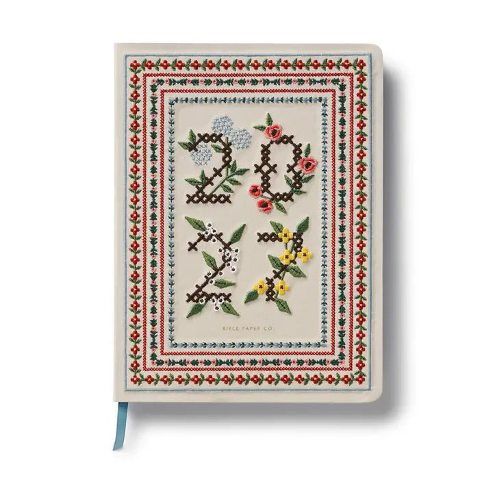 A daily essential with keepsake quality. With a cover inspired by classic cross stitch samplers, this fabric-wrapped planner features gold foil details, weekly and monthly views, space for notes and to-dos, and a list of celebrations.
DETAILS
Printed in full color with foil stamped year
Book cloth cover with ivory uncoated paper
Natural white text paper interior
January 2027-December 2027
Monthly and weekly views
Space for notes each week
List of celebrations
7.18" W x 9.62" L