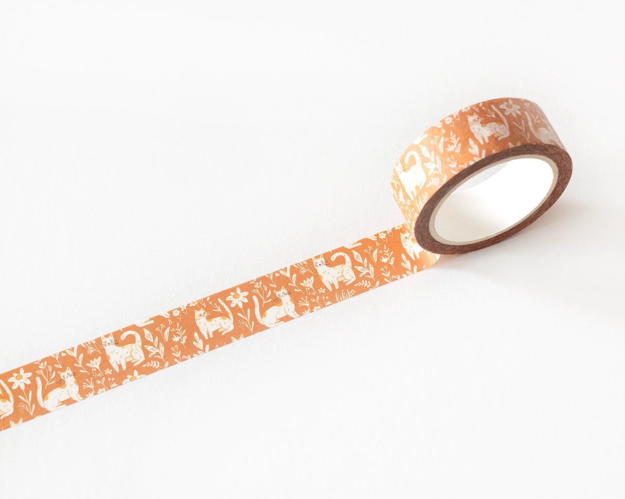 Celebrate your love for cats with our Whimsical Cats Washi Tape. Featuring an adorable design of playful cats amidst floral patterns on a warm mustard background, this washi tape is perfect for adding a touch of feline charm to your scrapbooking, journaling, card making, and other DIY projects. Measuring 10 meters in length, this washi tape is durable and easy to tear, making it ideal for both kids and adults. The delightful cat design is sure to bring joy and creativity to any project.