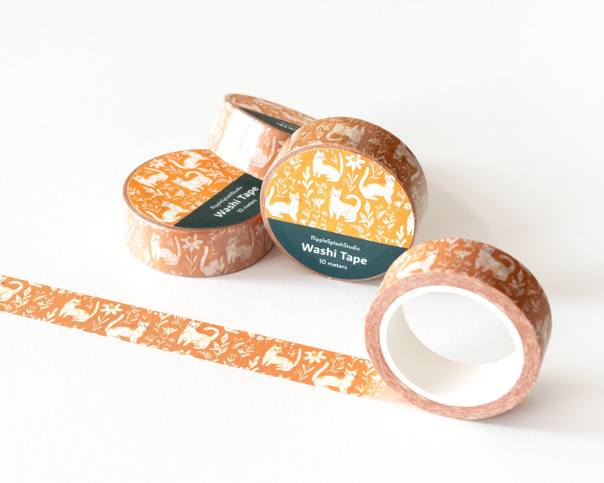 Celebrate your love for cats with our Whimsical Cats Washi Tape. Featuring an adorable design of playful cats amidst floral patterns on a warm mustard background, this washi tape is perfect for adding a touch of feline charm to your scrapbooking, journaling, card making, and other DIY projects. Measuring 10 meters in length, this washi tape is durable and easy to tear, making it ideal for both kids and adults. The delightful cat design is sure to bring joy and creativity to any project.