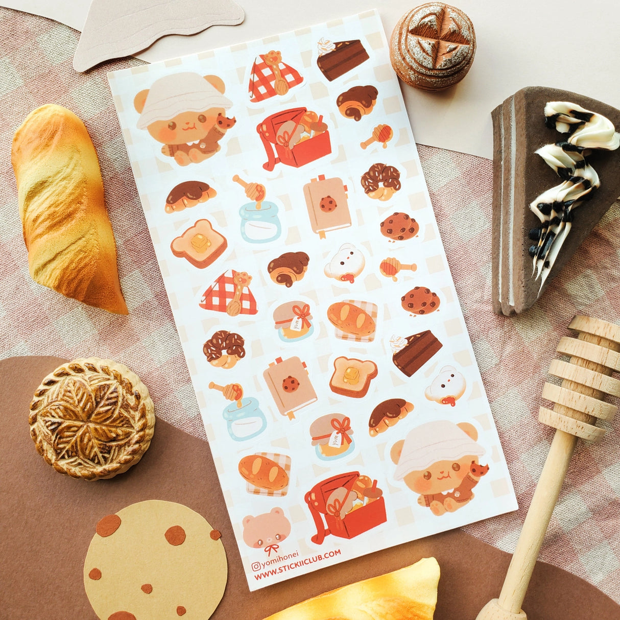 🧺🍯 Pack your blanket for the coziest little picnic! This darling sheet by @yomihonei is filled with flaky croissants, chocolatey buns, chunky cookies, golden loaves, buttery toast, and jars of honey all nestled on a gingham spread. With an adorable bear friend busy filling baskets and tying up tasty treats, it’s a kawaii afternoon of sunshine, crumbs, and cuddly bakery bliss. These stickers will add a drizzle of honeyed happiness wherever you stick them!
Art by: @yomihonei
Top Coating: None
Adhesive Lay