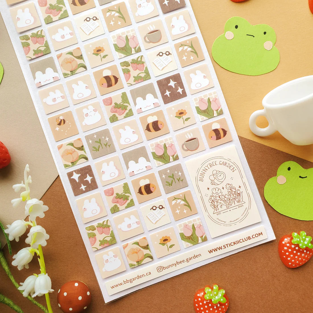 🌻🐝 Buzz on over to @bunnybee.garden’s whimsical garden, where chubby bunny-bees flutter through fields of flowers and cozy mushroom hideaways. From watering plants and zooming past blooming petals to splashing in puddles and snoozing in grassy corners, this sheet is bee-yond adorable.
Art by: @bunnybee.garden
Top Coating: None
Adhesive Layer: Paper
Backing Layer: Clear PET
6.69" x 3.54".
Weight - 0.03lbs.
1 sheet included