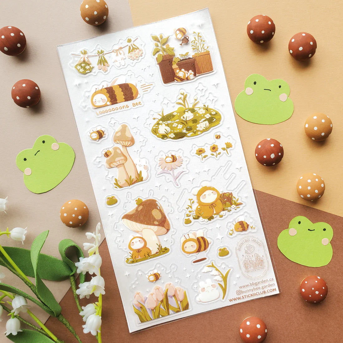🌻🐝 Buzz on over to @bunnybee.garden’s whimsical garden, where chubby bunny-bees flutter through fields of flowers and cozy mushroom hideaways. From watering plants and zooming past blooming petals to splashing in puddles and snoozing in grassy corners, this sheet is bee-yond adorable.
Art by: @bunnybee.garden
Top Coating: None
Adhesive Layer: PVC (plastic)
Backing Layer: Clear PET
6.69" x 3.54".
Weight - 0.03lbs.
1 sheet included