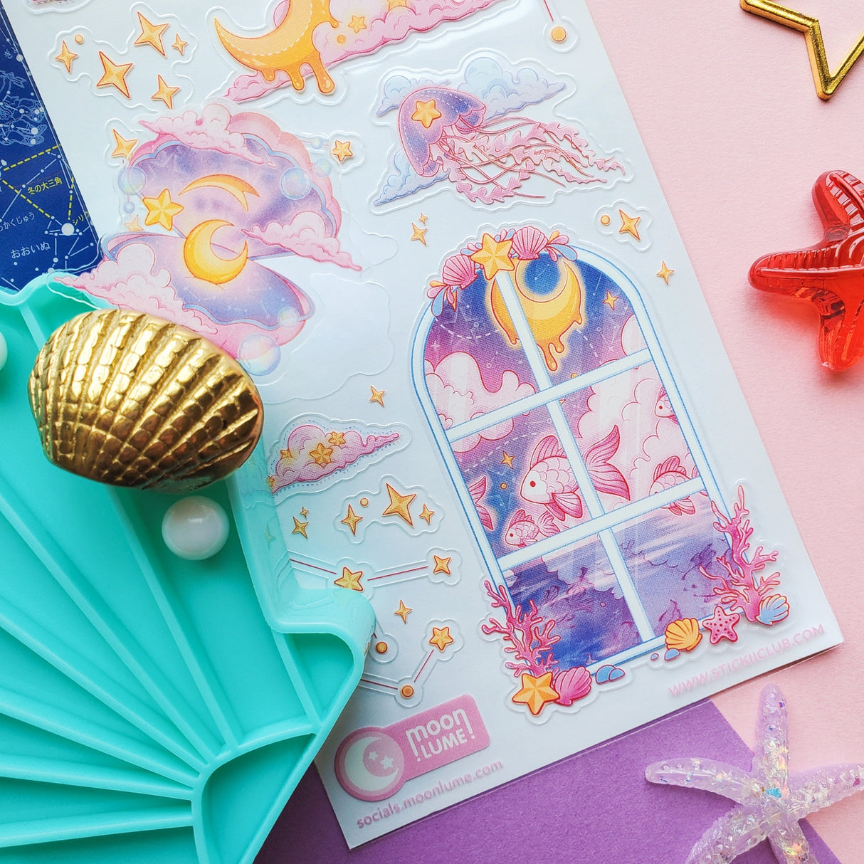Sticker sheet with celestial design featuring stars, moons, and windows on a pink background.