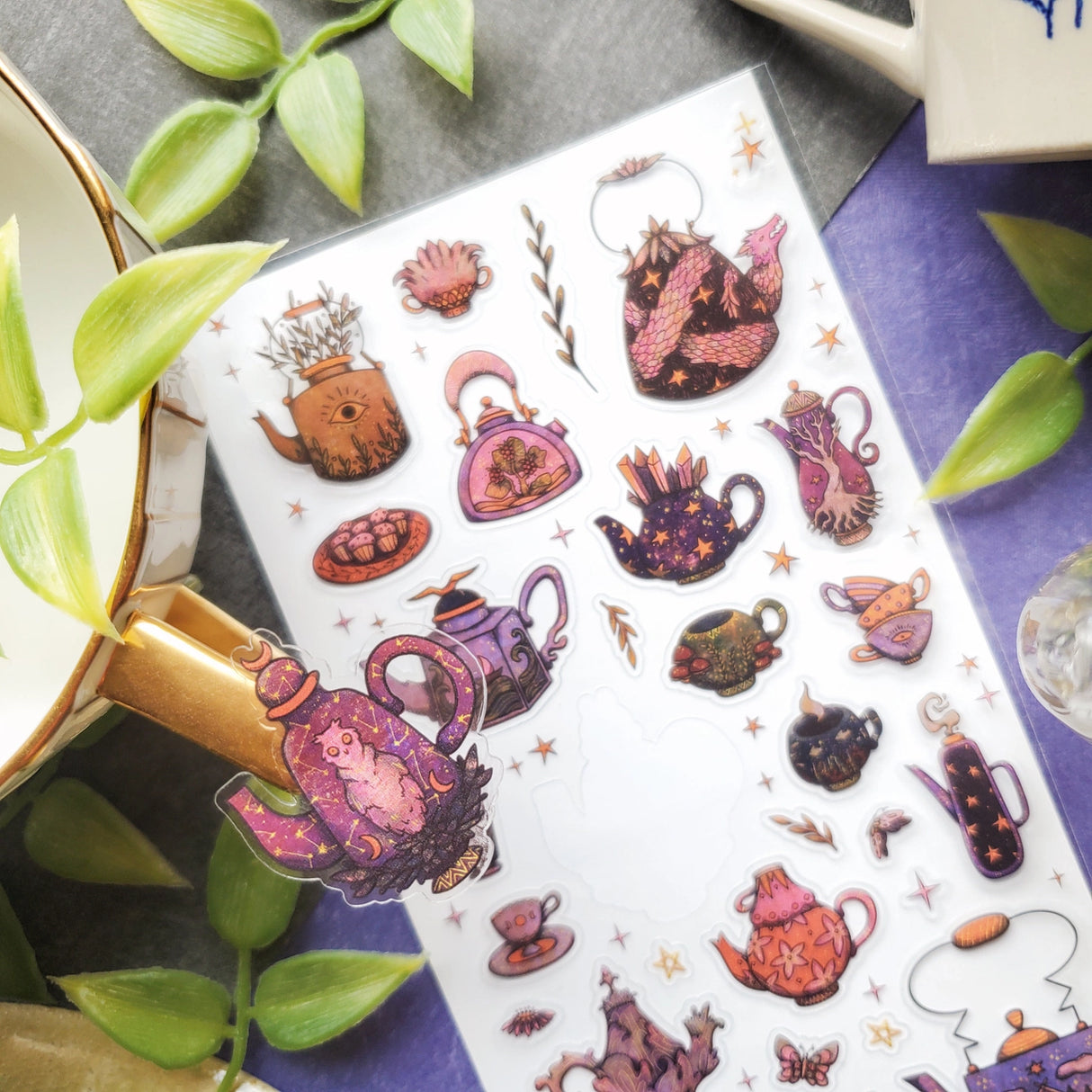 🫖✨ These enchanted pots and cups aren’t just for sipping—they’re hiding dragon guardians, crystal clusters, cosmic owls, and mushroom charms inside their swirling designs. Whether they’re steeping starlight, conjuring cosmic blends, or serving up a dash of forest magic, this mystical tea party is ready to pour a whole lot of wonder into your day!