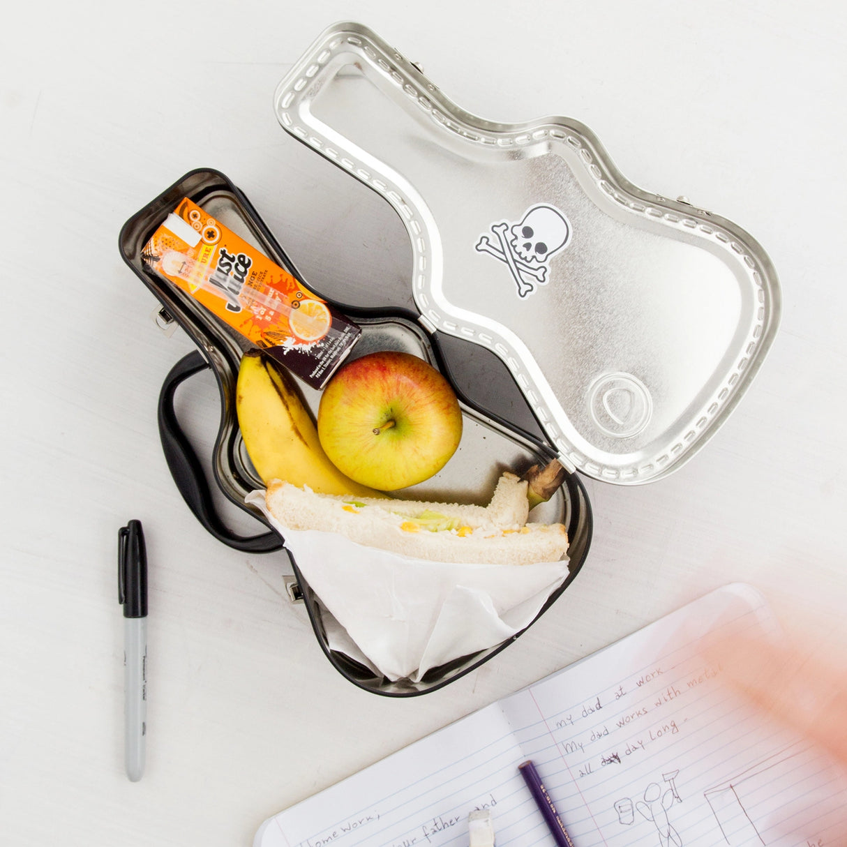 Lunch just got loud. This guitar-shaped tin lunchbox brings rock-n-roll attitude to school, work, or picnics. Keep sandwiches and snacks secure with a sturdy latch and carry handle, then personalise your case with the included set of stickers – just like a real tour pro. Made from durable, food-grade tin and designed to last, it’s the coolest way to carry your lunch on the road.