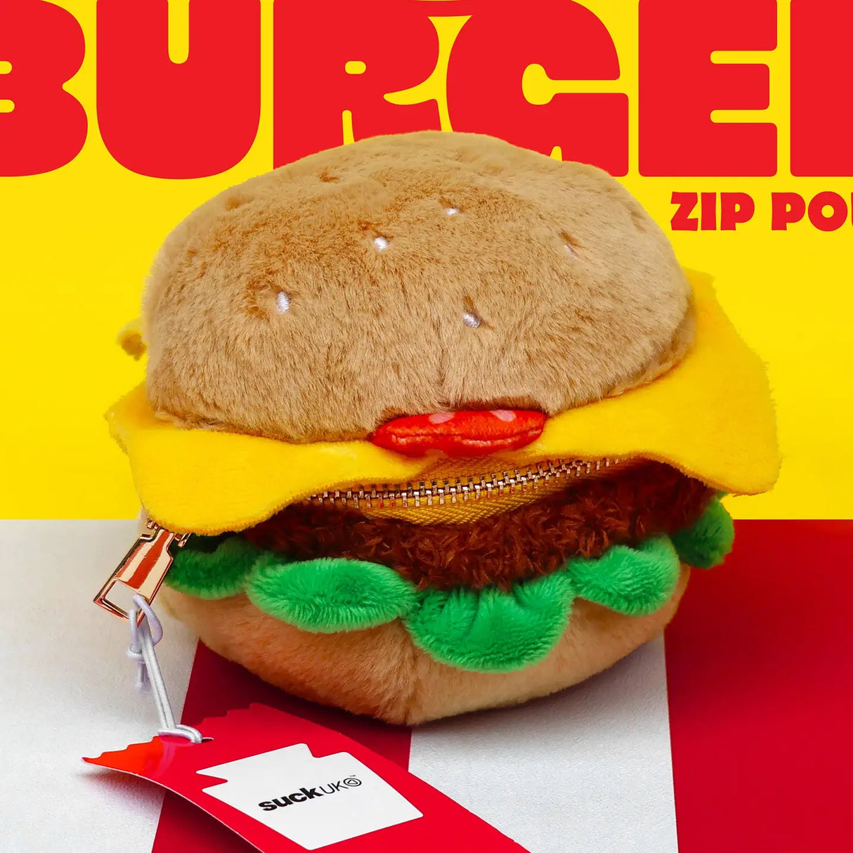 SUCK UK Plush Pouch - Hamburger
Plush burger shaped case with gold zip. Store your belongings amongst the salad and the melted cheese. Yum!
Juicy, tasty, sweet and sour. And very cute. Stuff your stuff into something soft, and squishy. Delicious looking plush zip pouches look like foodie treats but instead of calories, they hold your everyday essentials. From cheesy slices to sickly treats, each pouch is designed to be irresistible and practical. Perfect for pens, cables, cosmetics, or whatever bits and b