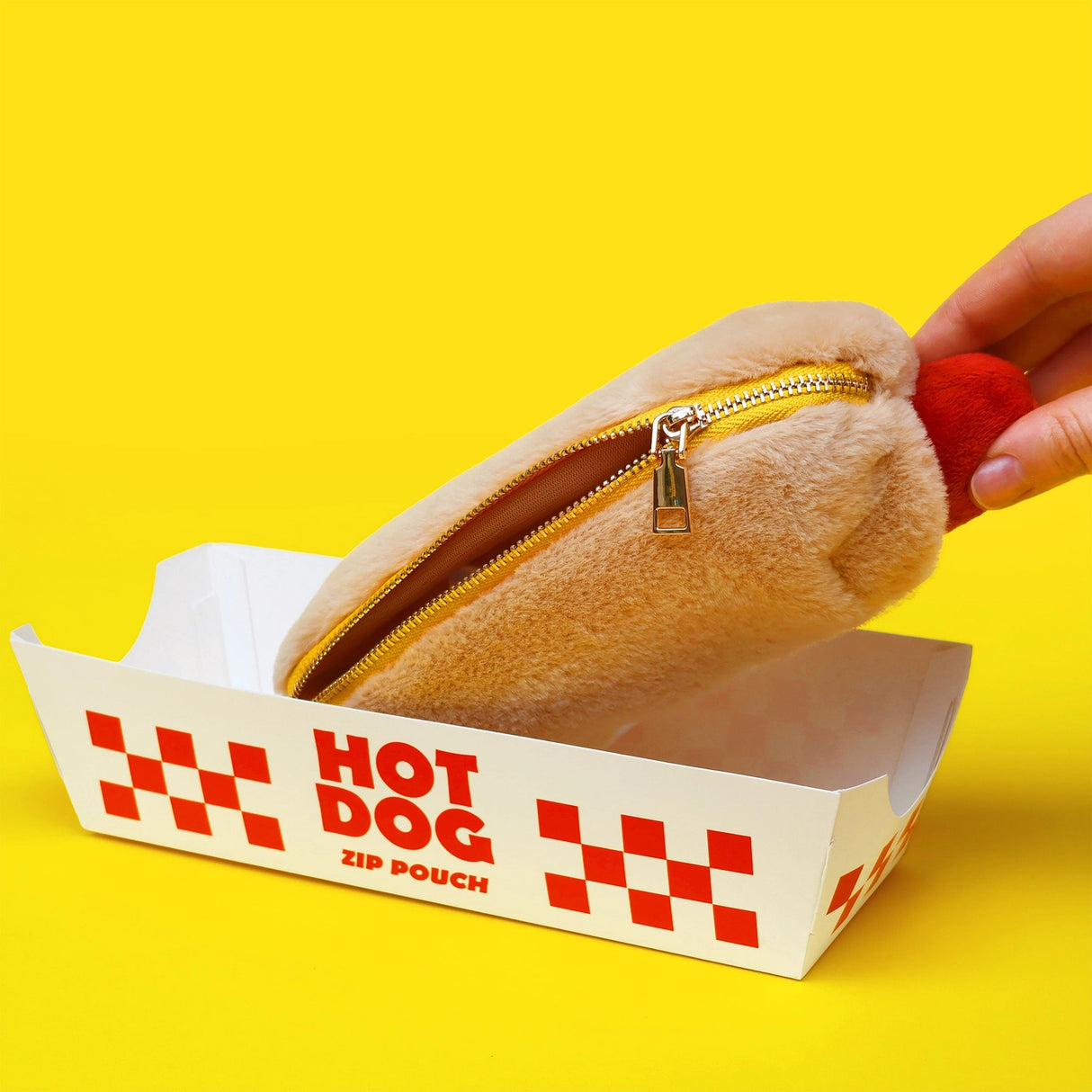 Store stationery or other small items
Plush hot dog shaped case with gold zip. Store your belongings in style by filling your hot dog bun full. Yum!
Plush Zip Pouches designed and made by SuckUK
Juicy, tasty, sweet and sour. And very cute. Stuff your stuff into something soft, and squishy. Delicious looking plush zip pouches look like foodie treats but instead of calories, they hold your everyday essentials. From cheesy slices to sickly treats, each pouch is designed to be irresistible and practical. Perf