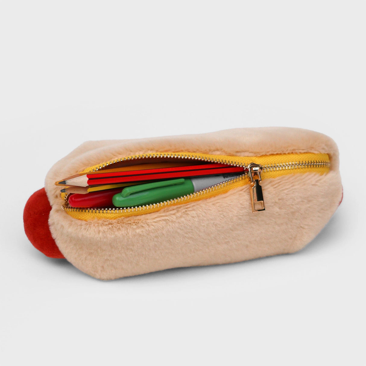 Store stationery or other small items
Plush hot dog shaped case with gold zip. Store your belongings in style by filling your hot dog bun full. Yum!
Plush Zip Pouches designed and made by SuckUK
Juicy, tasty, sweet and sour. And very cute. Stuff your stuff into something soft, and squishy. Delicious looking plush zip pouches look like foodie treats but instead of calories, they hold your everyday essentials. From cheesy slices to sickly treats, each pouch is designed to be irresistible and practical. Perf