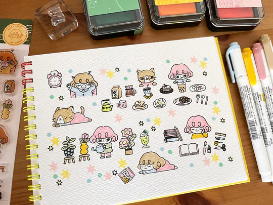 It starts with being woken up by an alarm clock, eating, drinking, watering flowers, enjoying notebook time, reading, and rumbling. Pepper's expression and gestures are very adorable stamps. My partner cat is also cute! It is practical and easy to use as a notebook.
This stamp set is a collaboration between Sakuralala and Love Soup, an Australian artist based in Japan that illustrates pictures of Lazy Girl Pepper. These stamps are the perfect addition for your journal or planner!