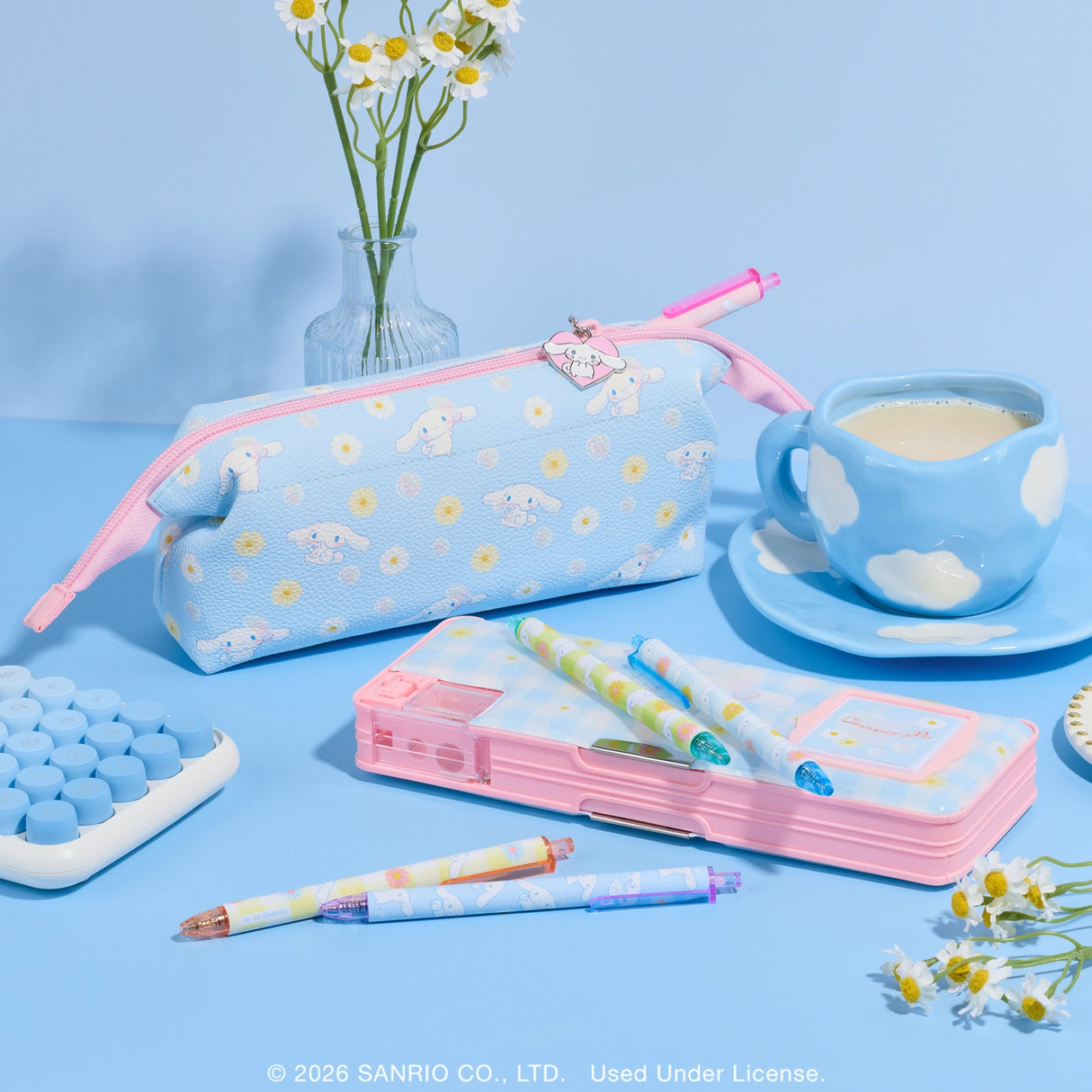Stay organized with this Cinnamoroll™ Pencil Case! It features two roomy compartments, a flip-up calculator, a pencil sharpener, and a magnetic closure. With plenty of storage space and a sweet gingham-and-daisies design, it's perfect for school, study sessions, or gifting to a Sanrio fan