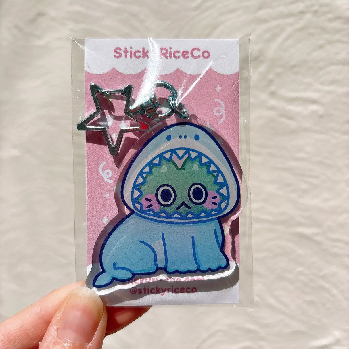 This shark cat keychain is the perfect accessory to your phone, purse, backpack, etc!
PLEASE NOTE: There may be plastic film covers on the backs of the keychains. The film is there to protect the keychains in transit and may look scratched. They can be removed to show shine/clarity on the surface.
Details:
2" in wide
ONE SIDED glitter epoxy with flat back
Double sided printing on sturdy acrylic
Colors may differ from picture due to lighting differences
Made in United States