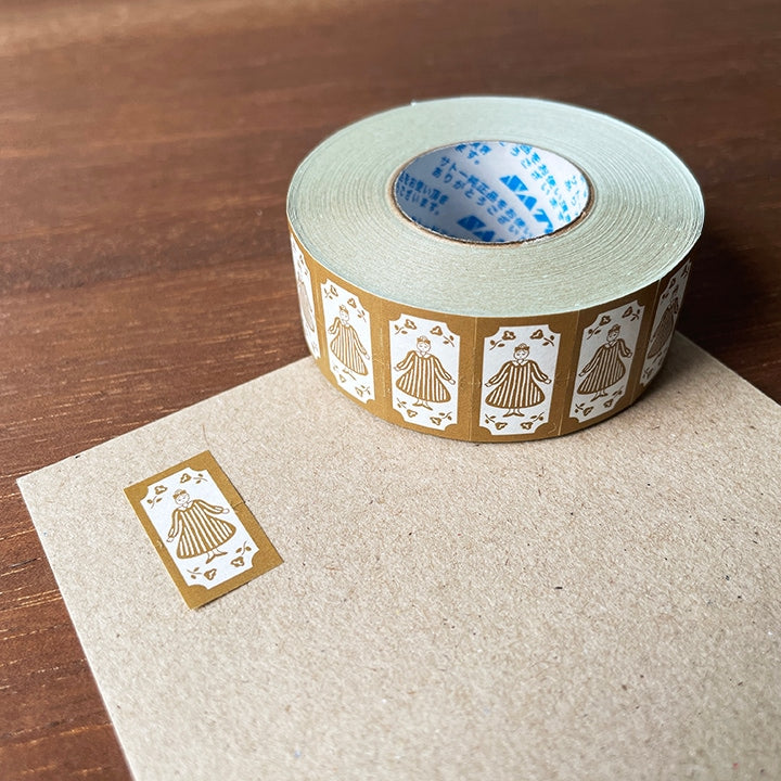 Stamp Marche Label Sticker Roll - Maru-chan Retro Brown Roll of decorative tape with gold designs on a wooden surface